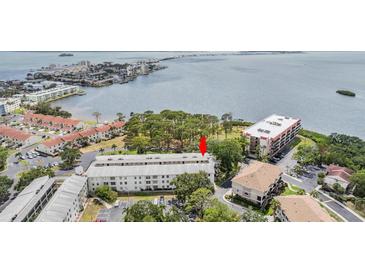 An aerial view of the condo complex near the water offers a serene and desirable living environment at 2700 Bayshore Blvd # 6210, Dunedin, FL 34698