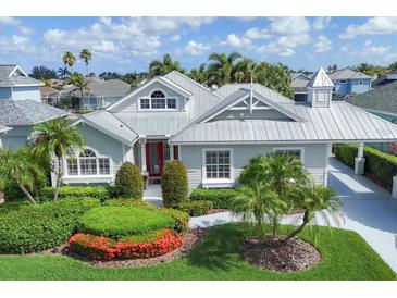Charming single-story home with meticulously landscaped yard and a distinctive red front door at 4743 Spinnaker Dr, Bradenton, FL 34208
