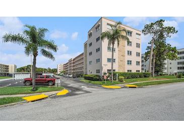 Inviting exterior view of building, showcasing a lush green landscape and convenient parking at 5623 80Th N St # 415, St Petersburg, FL 33709