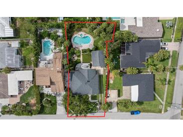 A captivating aerial view showcases this home and its large yard, complete with a pool and patio at 58 Aster St, Clearwater Beach, FL 33767