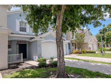 Charming townhome featuring light blue exterior paint and a one-car garage at 6231 Olivedale Dr, Riverview, FL 33578