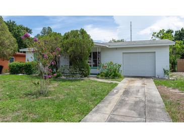 Charming single-story home featuring a well-maintained lawn, mature trees and landscaping at 760 72Nd N Ave, St Petersburg, FL 33702
