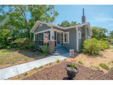 Charming bungalow with a screened front porch, brick accents, and a well-maintained yard at 917 W Idlewild Ave, Tampa, FL 33604