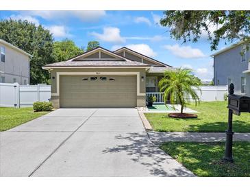 Charming single-story home featuring a well-manicured lawn, neutral paint, and a spacious two-car garage at 9831 Edmonton Dr, Land O Lakes, FL 34638