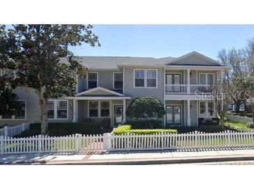 Charming two-story townhome featuring a white picket fence and welcoming front porches at 291 1St Sw Ave, Largo, FL 33770