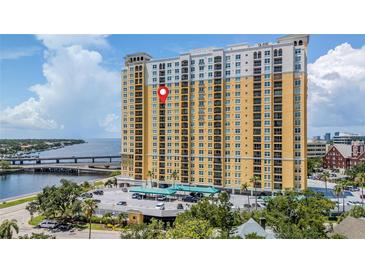 High-rise building featuring a vibrant yellow facade and balconies, nestled near waterfront and city views at 345 Bayshore Blvd # 1510, Tampa, FL 33606