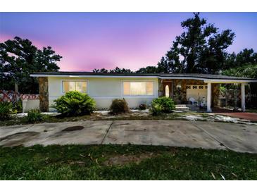 Charming single-story home featuring stone accents, a covered carport, and well-maintained landscaping at 3601 27Th S Ave, St Petersburg, FL 33711