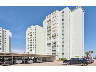 View of the building's exterior, with multiple floors and parking underneath at 400 64Th Ave # 202, St Pete Beach, FL 33706