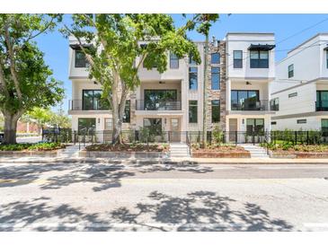 Contemporary townhomes with stone accents, black metal fences, and landscaped front yards add curb appeal at 50 64Th S St, St Petersburg, FL 33707