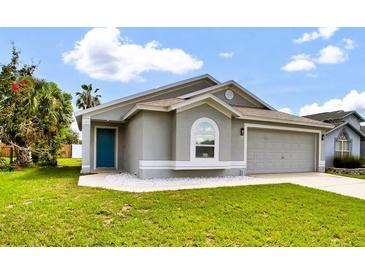 Well-maintained single-Gathering home with a gray exterior and a two-car garage at 1706 Erin Brooke Dr, Valrico, FL 33594