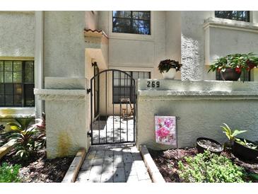 Charming condo entrance with a gated courtyard and well-maintained landscaping for inviting curb appeal at 269 Los Prados Dr # 1011, Safety Harbor, FL 34695