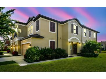 Charming two-story home with a well-manicured lawn and lush landscaping, perfect for a Gathering at 11519 Crowned Sparrow Ln, Tampa, FL 33626