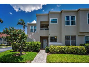 Inviting two-story condo featuring well-maintained landscaping and private entrance with stairs and neutral paint at 6080 Bahia Del Mar Cir # 109, St Petersburg, FL 33715