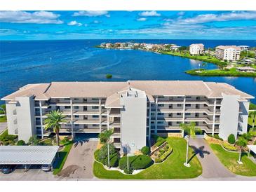 Beautiful waterfront condo complex with manicured landscaping, covered parking, and stunning water views at 8211 Brent St # 815, Port Richey, FL 34668