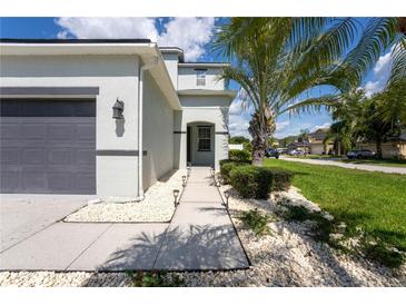 Inviting front yard featuring lush landscaping, decorative stones, and a well-maintained walkway at 9110 Lantern Oak Way, Land O Lakes, FL 34638