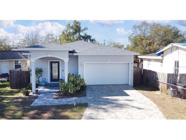 Charming single-story home featuring a well-manicured lawn and a two-car garage with a brick-paved driveway at 5528 40Th N St, St Petersburg, FL 33714
