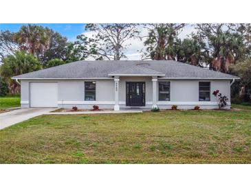 Charming single-story home with a well-manicured lawn and a classic architectural design at 5580 S Salford Blvd, North Port, FL 34287
