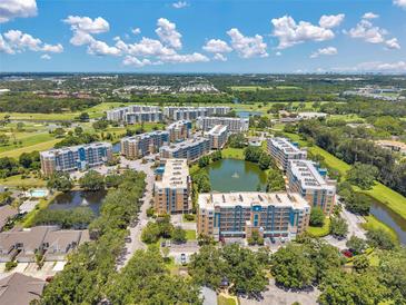 Expansive aerial view of condo community with lakes, landscaping, and golf course at 960 Starkey Rd # 10505, Largo, FL 33771