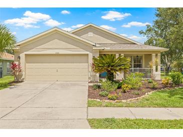 Charming single-Gathering home with well-manicured lawn and an attached two-car garage at 11830 Autumn Creek Dr, Riverview, FL 33569