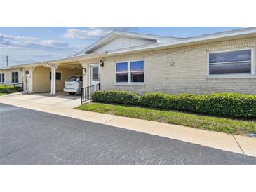 Charming one-story villa featuring a covered carport, well-maintained landscaping, and a welcoming entrance at 12400 Park Blvd # 519, Seminole, FL 33772