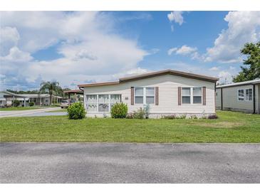 Charming single-story home featuring vinyl siding, green lawn, and a clean, well-maintained front yard in a friendly neighborhood at 5706 Benton St, Zephyrhills, FL 33542