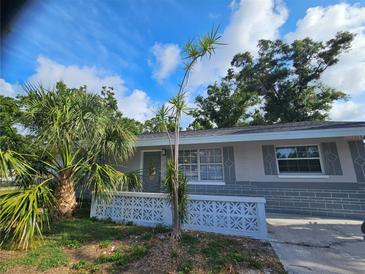 Charming single story home featuring a decorative breeze block fence and tropical landscaping at 7001 60Th N St, Pinellas Park, FL 33781
