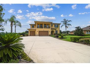 Stunning two-story home featuring an oversized driveway and manicured landscaping at 17914 Howsmoor Pl, Lutz, FL 33559