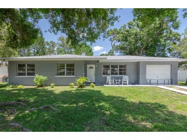 Charming single-story home with a well-maintained front yard and attached one car garage at 4917 99Th N St, St Petersburg, FL 33708