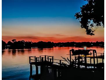 Beautiful waterfront view from a pier, displaying the captivating sunset and calming silhouette in the horizon at 739 Chesapeake Dr, Tarpon Springs, FL 34689
