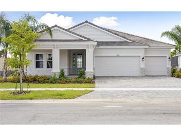 Charming single Gathering home with manicured landscaping and a three-car garage at 11622 Gleaming Ter, Venice, FL 34293