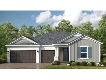 Charming single-story home with a two-car garage and welcoming front entrance and beautiful landscaping at 1633 Trailhead Ln, Zephyrhills, FL 33541