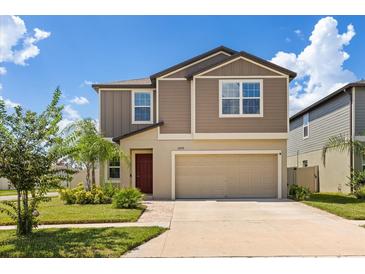 Charming two-story home features a neutral color scheme, well-maintained landscaping, and an attached two-car garage at 22359 Storybook Cabin Way, Land O Lakes, FL 34637