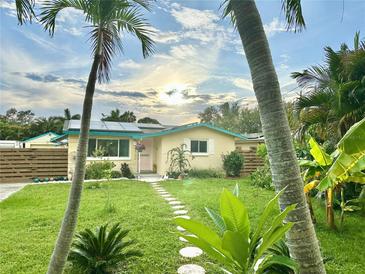 Charming single-story home featuring lush landscaping, stepping stone pathway, and freshly cut grass at 2707 56Th S St, Gulfport, FL 33707