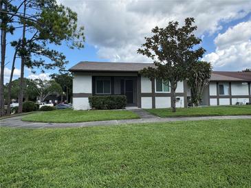 Charming single-story home with well-maintained lawn, mature tree, and welcoming front entrance at 2900 Grovewood Blvd # A, Palm Harbor, FL 34683