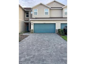 Charming townhome with a paved driveway and two-car garage offering great curb appeal at 11634 Woodleaf Dr, Bradenton, FL 34211