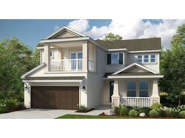 Charming two-story home featuring a two car garage and a balcony with white railings at 1806 Longliner Loop, Wesley Chapel, FL 33543