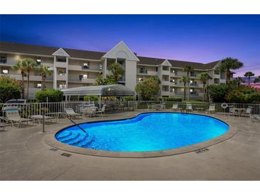 Inviting community pool with a covered seating area perfect for relaxation and enjoying the outdoors in this condo community at 5567 Sea Forest Dr # 323, New Port Richey, FL 34652