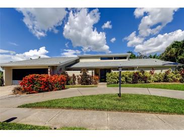 Beautiful single-story home with mature landscaping and a circular driveway at 604 Knollwood Dr, Largo, FL 33770