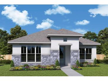 Charming single-story home featuring stone accents, well-manicured lawn, and inviting front entrance at 699 Allora Ave, Nokomis, FL 34275