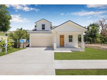 Charming two-story home with a well-manicured lawn and a cozy front porch at 7617 Alvina St, Tampa, FL 33625