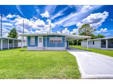 Charming single story home with well-maintained lawn and covered parking at 35014 Carl Ave, Zephyrhills, FL 33541