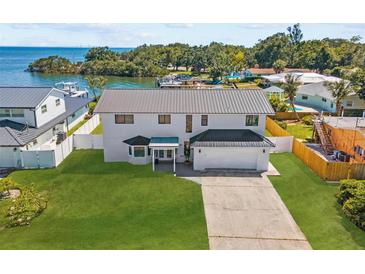 Stunning waterfront property featuring a modern two-story home with a lush lawn at 380 Colony Point S Rd, St Petersburg, FL 33705