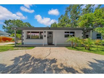 Charming single-story home featuring a covered entryway and a spacious driveway at 762 77Th N Ave, St Petersburg, FL 33702