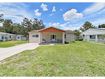 Charming single-story home with a well-maintained front yard and inviting curb appeal under a sunny sky at 9413 Forest Hills Dr, Tampa, FL 33612
