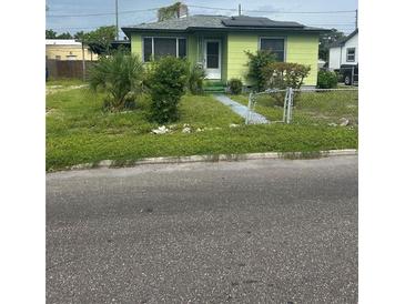 Charming single-Gathering home with mature landscaping, solar panels, and a cozy front entrance at 1557 15Th S St, St Petersburg, FL 33705