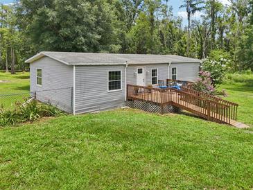 Charming single-story home features a wooden ramp leading to a cozy front deck at 26223 Chianina Dr, Wesley Chapel, FL 33544