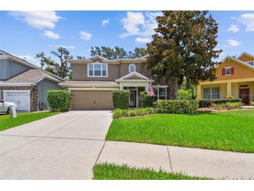 Charming two-story home with a well-maintained lawn and beautiful landscaping at 3530 Brook Crossing Dr, Brandon, FL 33511