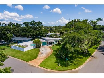 Charming single-story home featuring a spacious yard, inviting pool area, and a modern design at 3700 56Th N St, St Petersburg, FL 33710