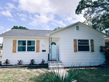 Charming single-story home featuring a new roof, fresh exterior paint, decorative shutters and landscaped yard at 811 40Th S Ave, St Petersburg, FL 33705