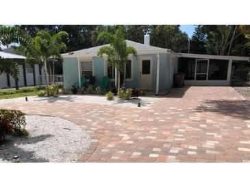 Charming single-story home with brick driveway and tropical landscaping at 111 12Th Ave, Indian Rocks Beach, FL 33785